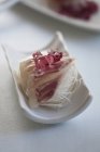 Bream sashimi on strips of radish over white surface — Stock Photo