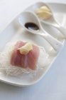 Tuna sashimi with ginger on white plate with spoons — Stock Photo