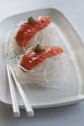 Salmon sashimi on radish strips — Stock Photo