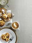Cinnamon buns and a cappuccino — Stock Photo