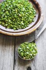 Organic peas on spoon — Stock Photo