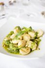 Closeup view of Gnocchi with Pesto and pine nuts — Stock Photo