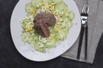 Beef tatar on cucumber and egg salad — Stock Photo
