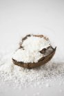 Flakes in coconut shell — Stock Photo