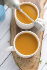 Cups of butternut squash soup — Stock Photo