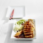 Closeup view of sliced Teriyaki chicken with vegetable pasta — Stock Photo