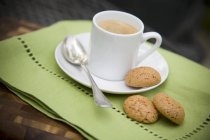 Brown Macaroons with cup — Stock Photo