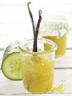 Cucumber preserve with vanilla in jar on white surface — Stock Photo