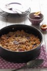 Closeup view of plum crumble in baking dish — Stock Photo