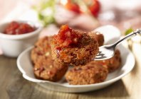 Kidney bean fritters on white plate with fork — Stock Photo