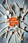 Top view of All You Can Eat sign surrounded by cutlery — Stock Photo
