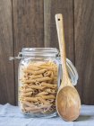 Jar of wholemeal penne pasta — Stock Photo