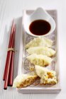 Closeup view of stuffed Japanese Gyozas dumplings with soy sauce — Stock Photo