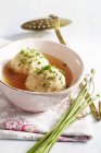 Closeup view of bacon dumpling soup with herbs — Stock Photo