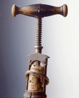 Closeup view of an antique corkscrew with a cork — Stock Photo