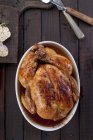 Roasted whole chicken with garlic — Stock Photo