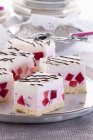 Cream slices with red jelly cubes — Stock Photo