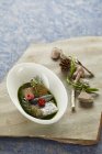 Sea trout in herb stock — Stock Photo