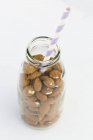 Almonds in a milk bottle — Stock Photo