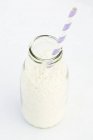 Coconut flakes in bottle — Stock Photo