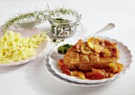 Ossobucco with tagliatelle pasta — Stock Photo