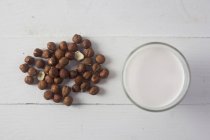 Hazelnut milk on white surface — Stock Photo