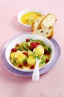 Fruit salad with orange dressing and bread — Stock Photo