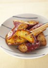 Deep fried sweet potato  on white plate with chopsticks — Stock Photo