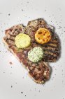 Grilled T-bone steak with herb butter — Stock Photo