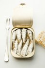 Tin of sardines with a fork and crackers — Stock Photo