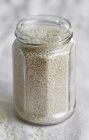 Jar of white sesame seeds — Stock Photo