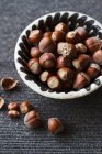 Hazelnuts in ceramic bowl — Stock Photo