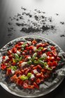 Pizza preta com pimentas — Fotografia de Stock
