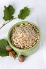 Closeup view of whole and grated hazelnuts — Stock Photo