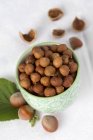 Shelled hazelnuts in ceramic bowl — Stock Photo