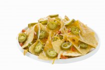 Nachos with cheese and jalapeos — Stock Photo