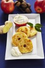 Closeup view of fried apple and coconut rings with ginger and quark cream — Stock Photo