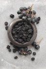 Fresh and dried Aronia berries — Stock Photo