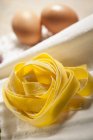 Fresh raw uncooked tagliolini pasta — Stock Photo