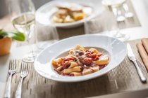 Paccheri pasta with bacon and chillis — Stock Photo