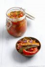 Ratatouille preserved in jar over white surface — Stock Photo
