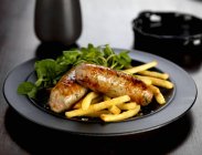 Pork sausages with french fries — Stock Photo