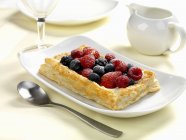Fruits and cream in puff pastry — Stock Photo