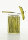 Dill Pickles in jar with fork on white background — Stock Photo