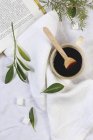 Black coffee in cup with wooden spoon — Stock Photo