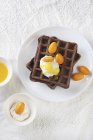 Cocoa waffles with orange sauce — Stock Photo