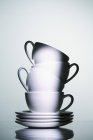 Closeup view of stacked white cups and saucers — Stock Photo