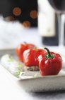 Oven-grilled mini peppers on white surface — Stock Photo