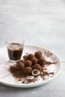 Closeup view of marzipan truffles and espresso — Stock Photo