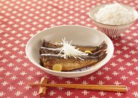 Closeup view of sardines simmered in ginger soy sauce — Stock Photo